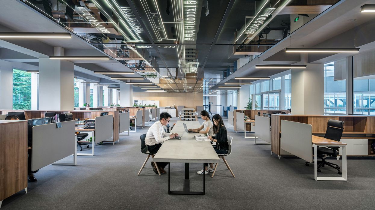 People at a communal table in an office building