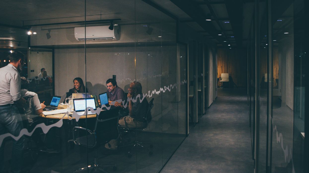 People having a meeting in a dark office