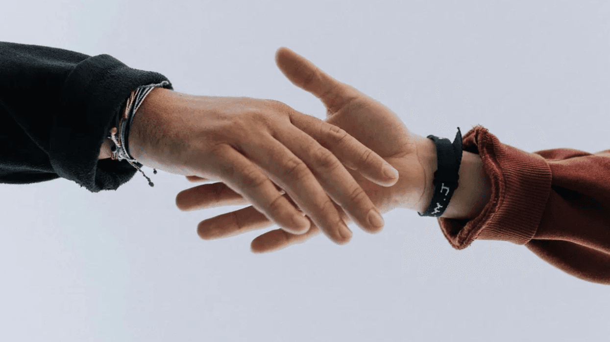 people reaching to shake hands