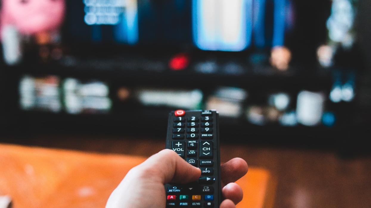 Person aiming a remote at a TV