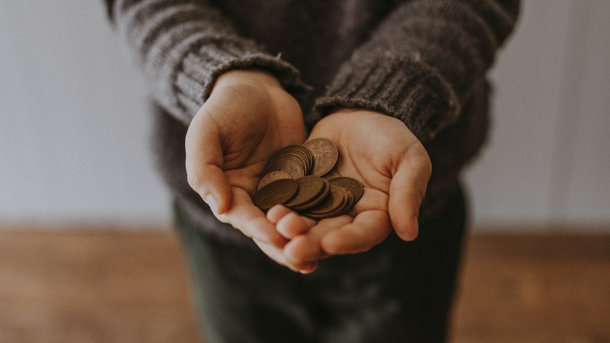 Person holding a handful of coins