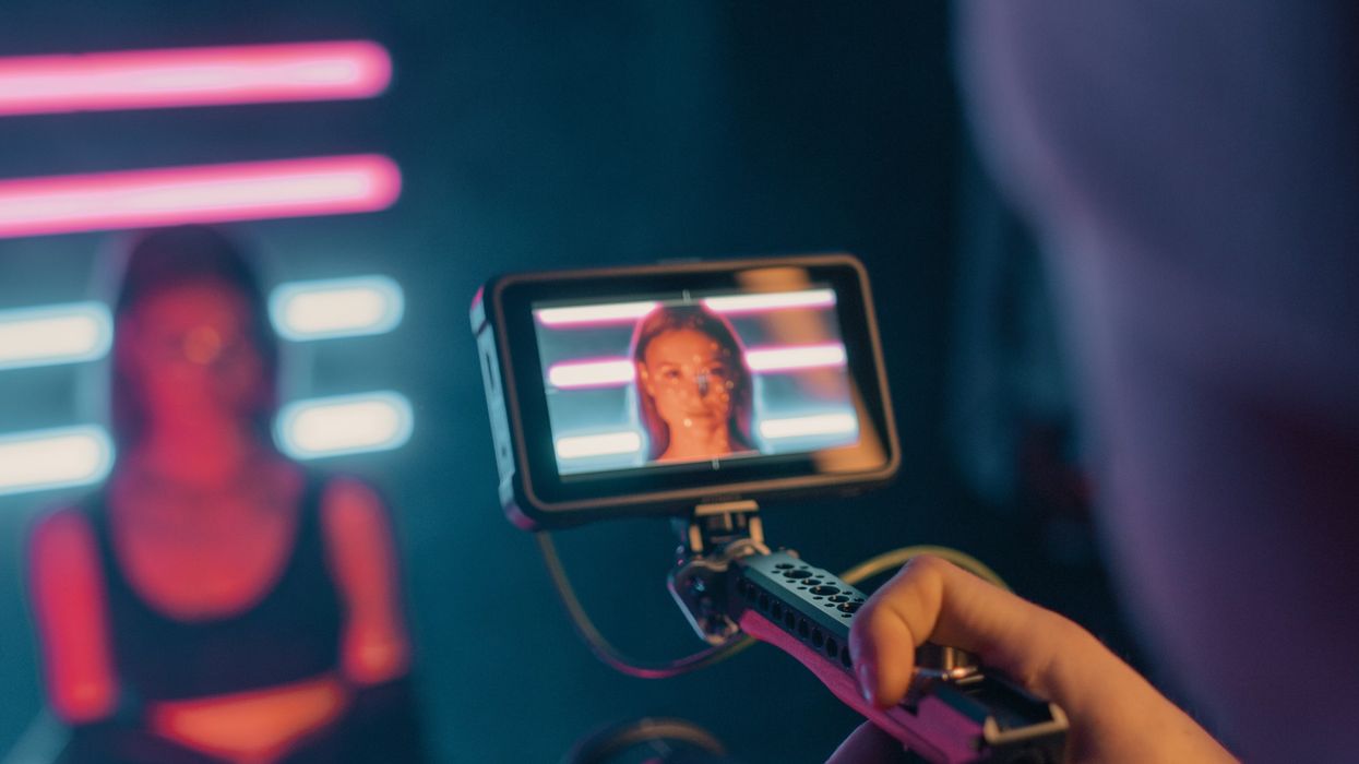 person holding black smartphone taking photo of man in black shirt
