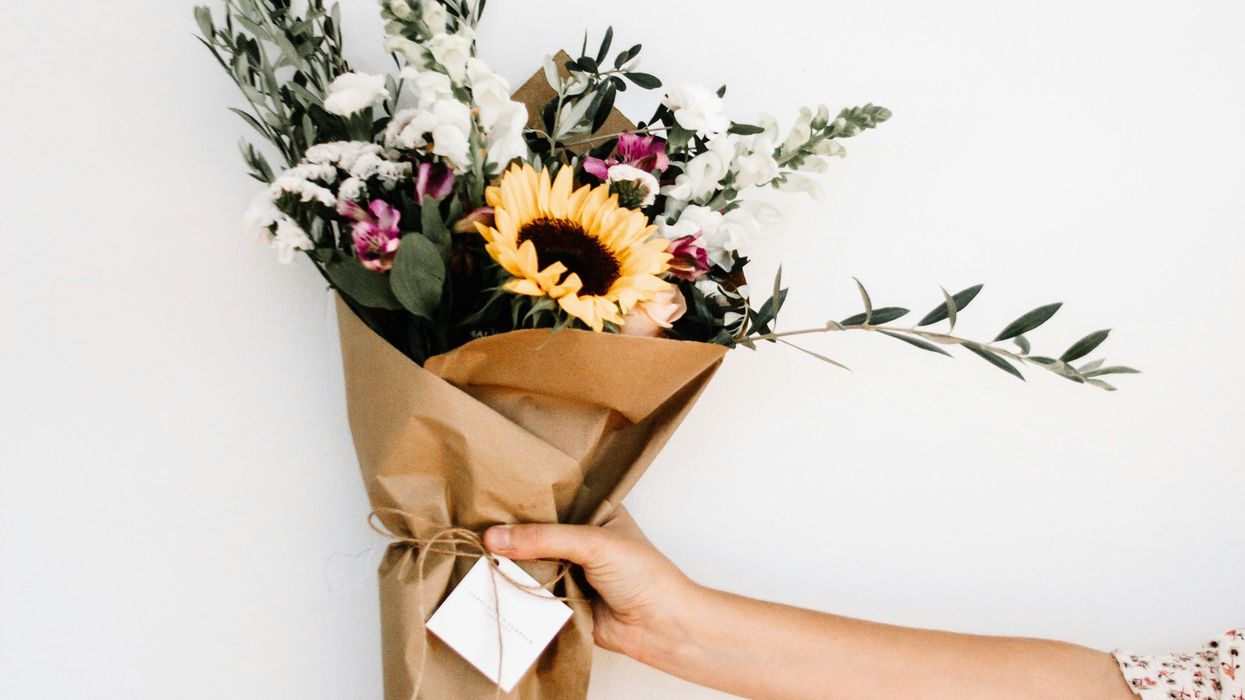 Person holding bouquet of flowers