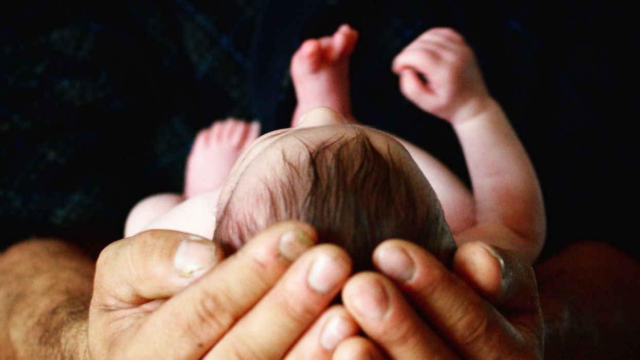 Person holding newborn baby