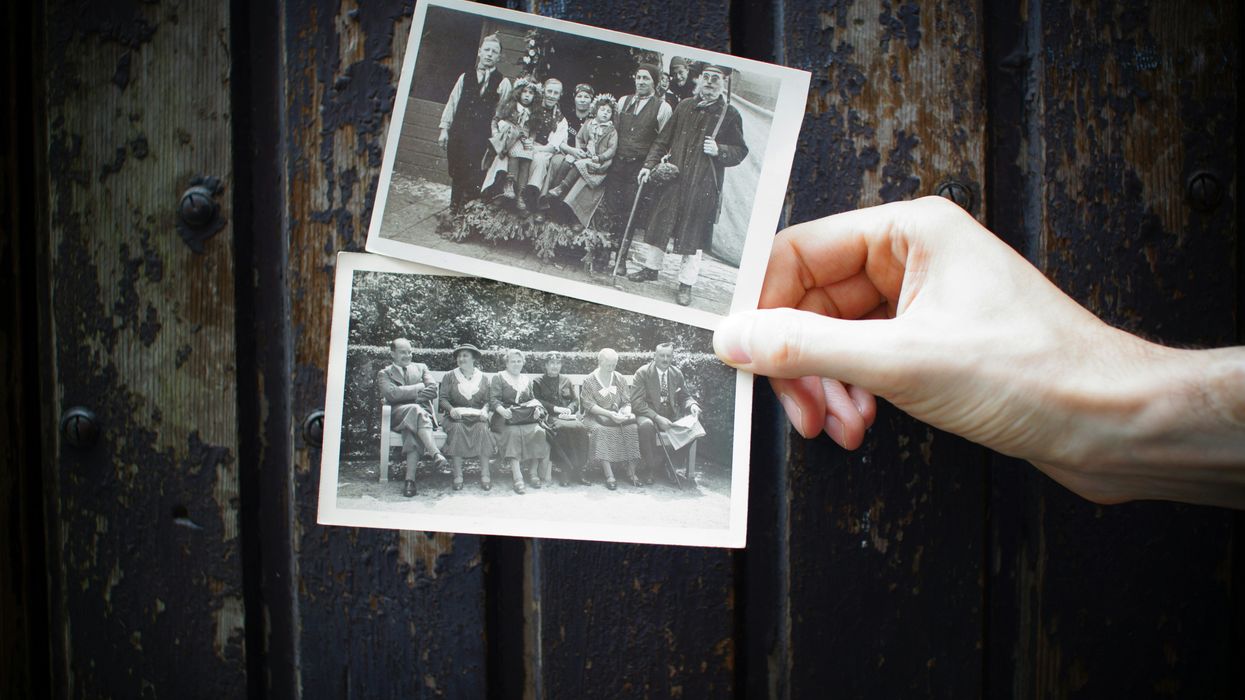 person holding old family photos