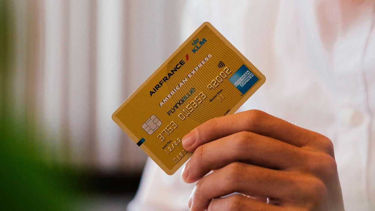 Person holding up an award services card