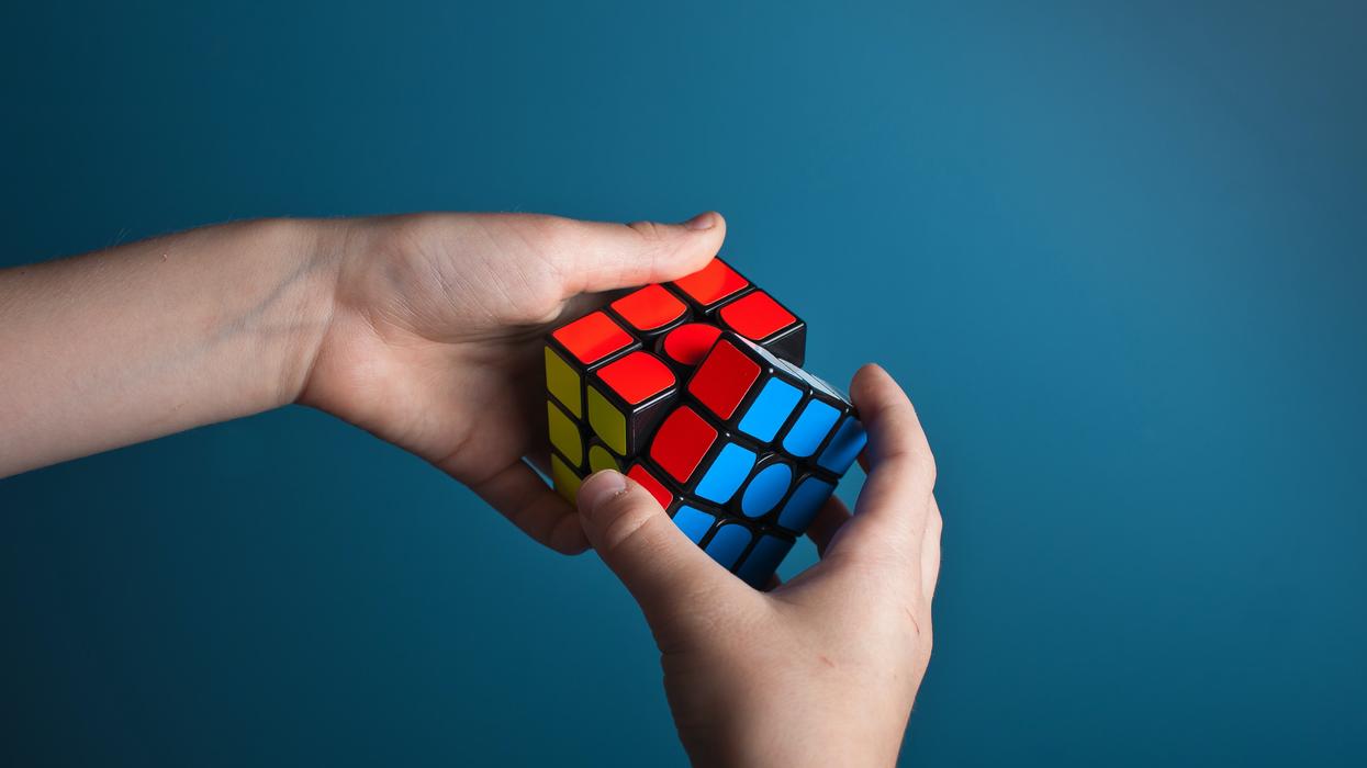 Person solving a Rubik's cube