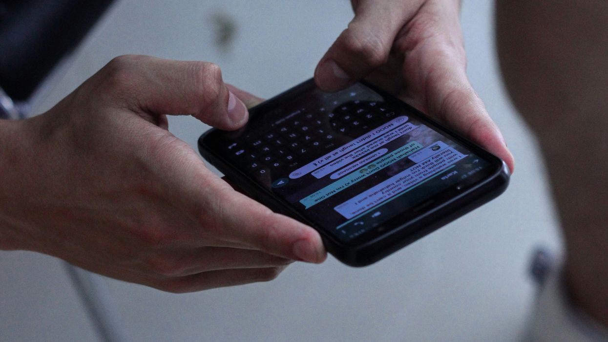 person texting on black iPhone