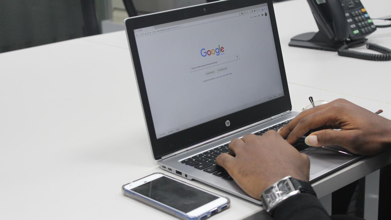 Person using laptop and searching on Google