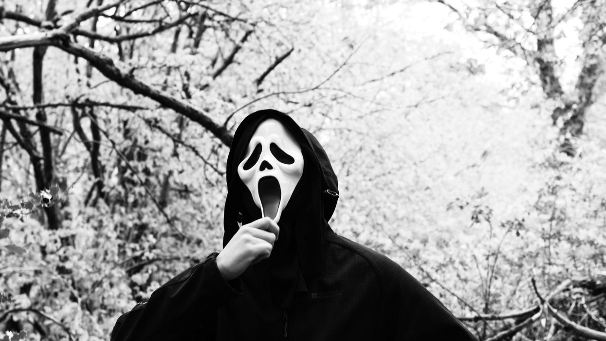 Person wearing a "Scream" mask from the slasher movie