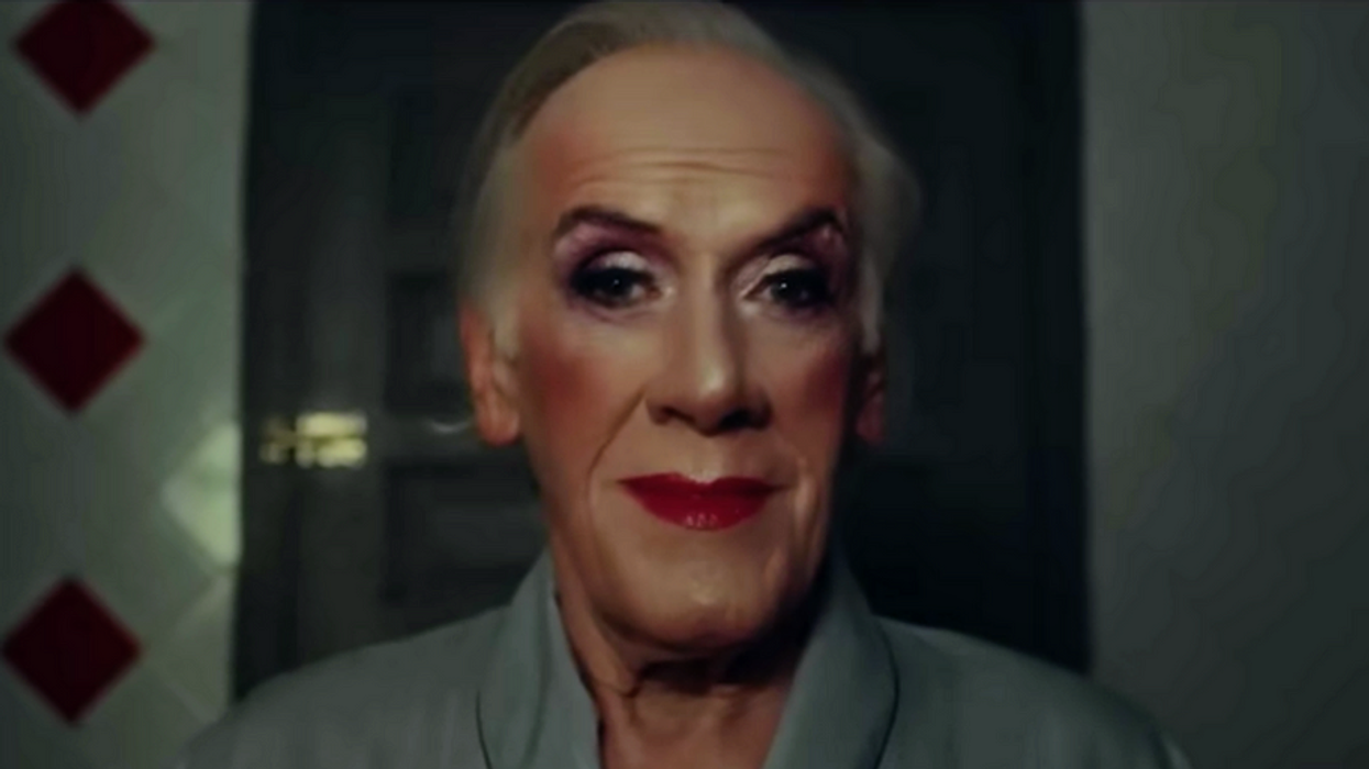 person wearing makeup looking in a mirror