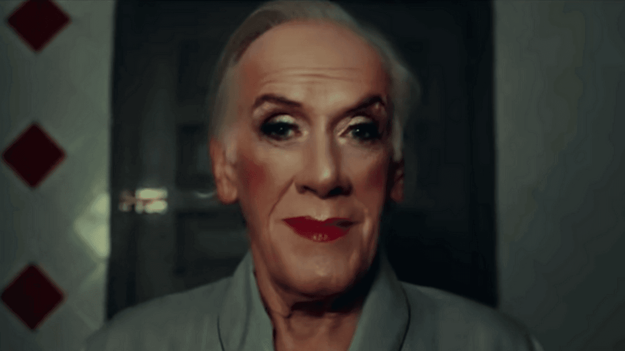 person wearing makeup looking in a mirror