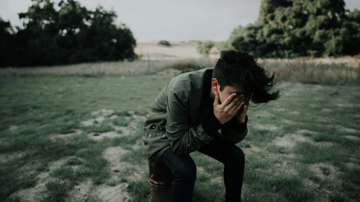 Person with their face in their hands