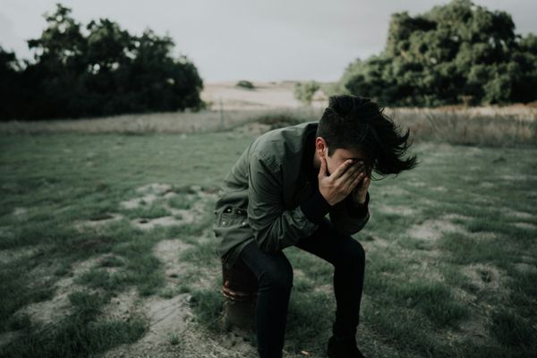 Person with their face in their hands