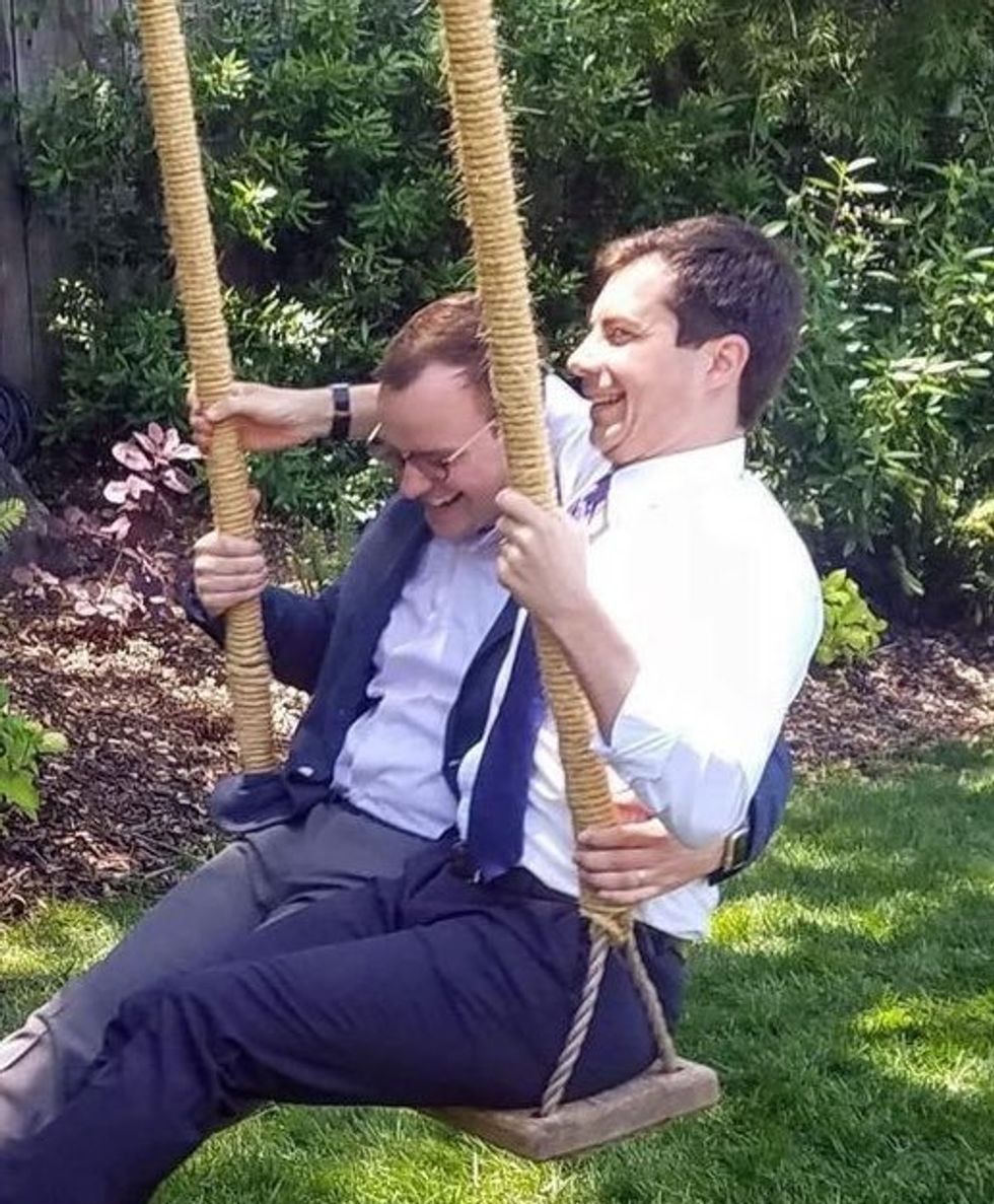 Pete and Chasten Buttigieg on a swing