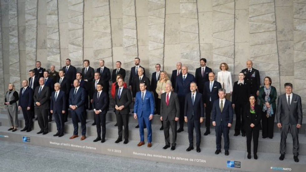 Pete Hegseth in blue suit, pictured with other leaders at NATO