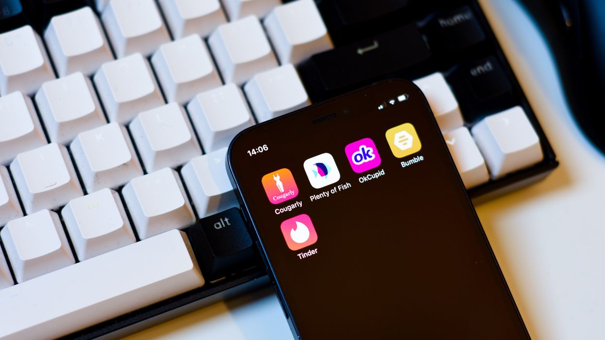 Phone with dating apps lyinfg on a keyboard