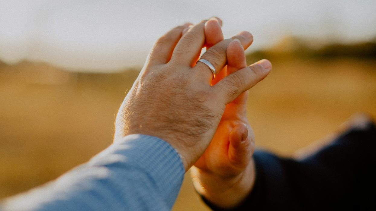 Photo of an elderly couple's hands touching.