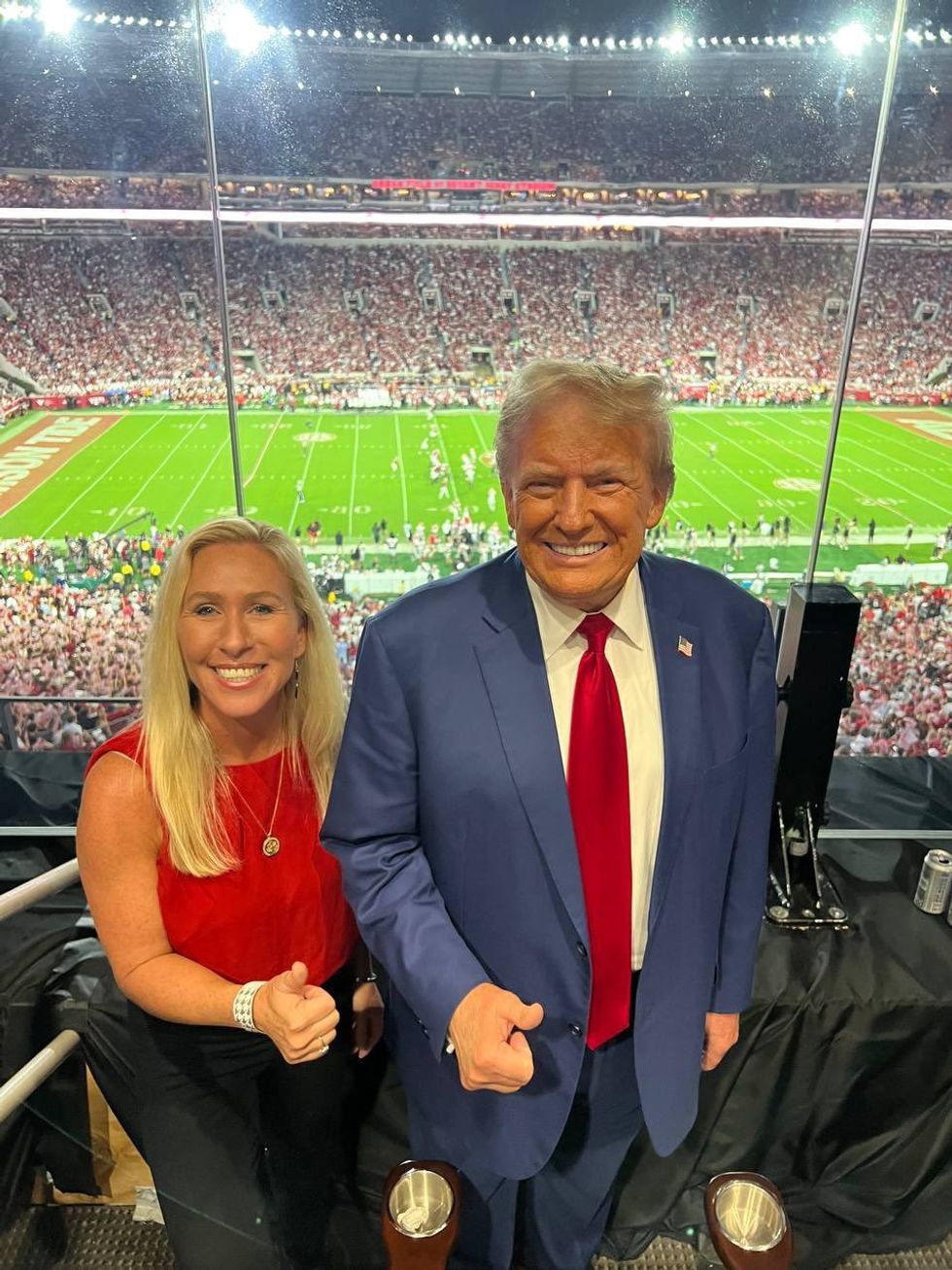 Photo of Marjorie Taylor Greene and Donald Trump at football game