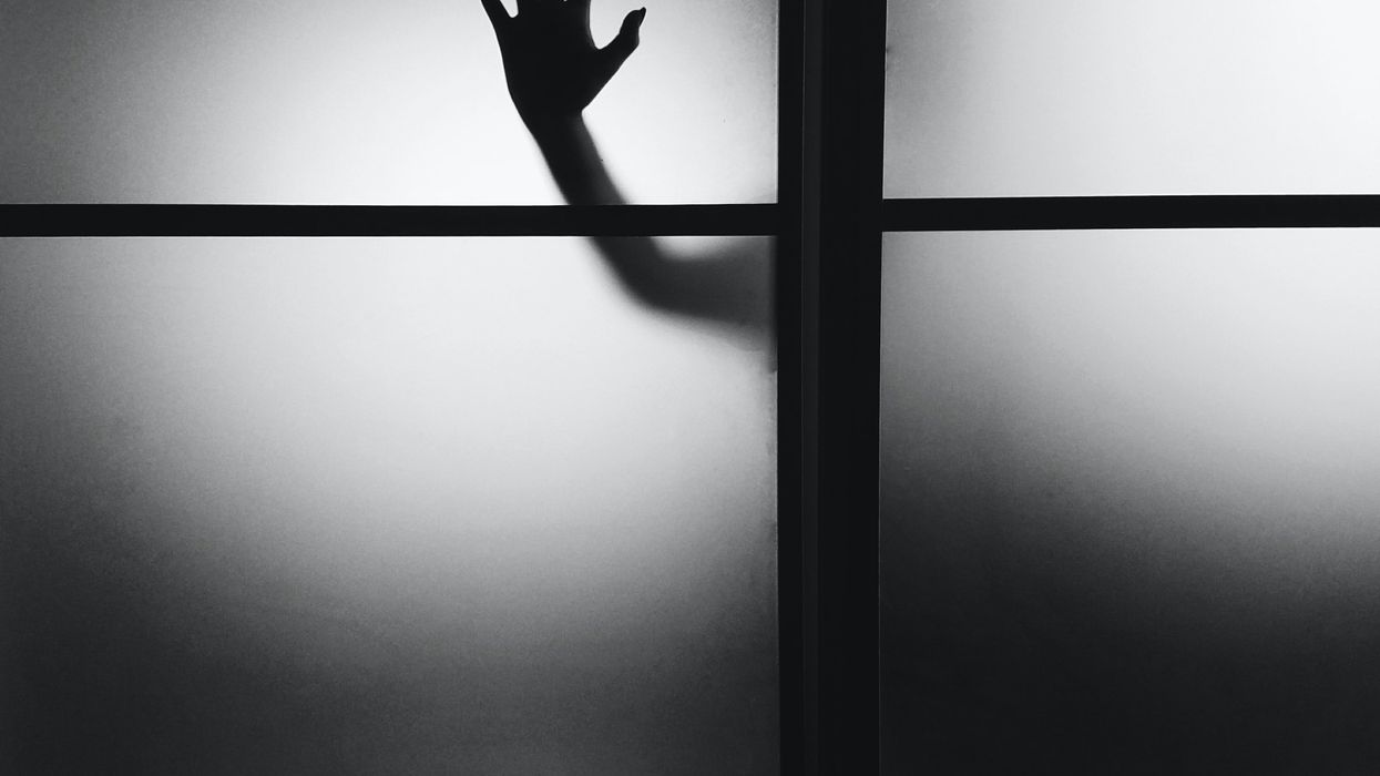 photo of person's hand on wall