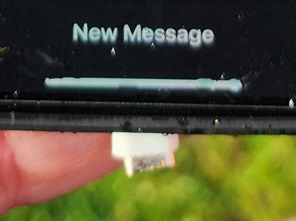 Photo of ripped off charging plug on iPhone