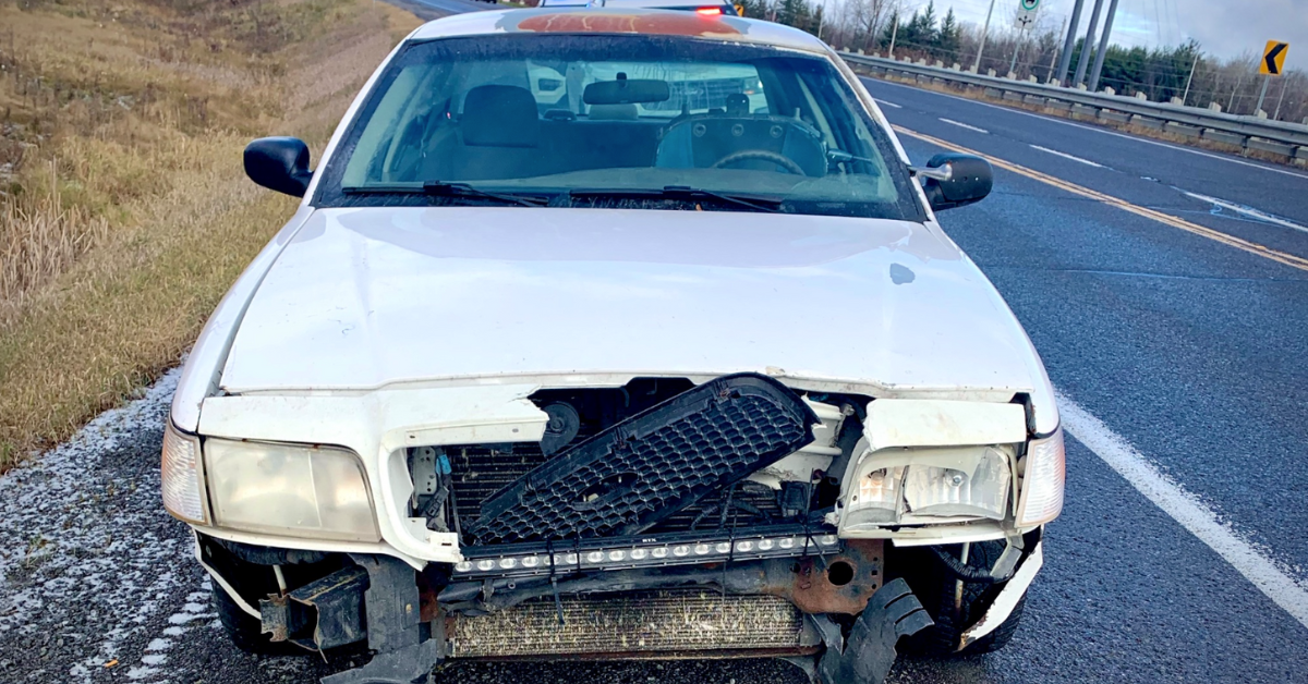 Photo of the vehicle, a banged-up white car