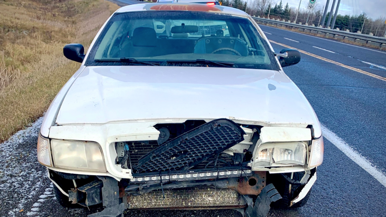 Photo of the vehicle, a banged-up white car