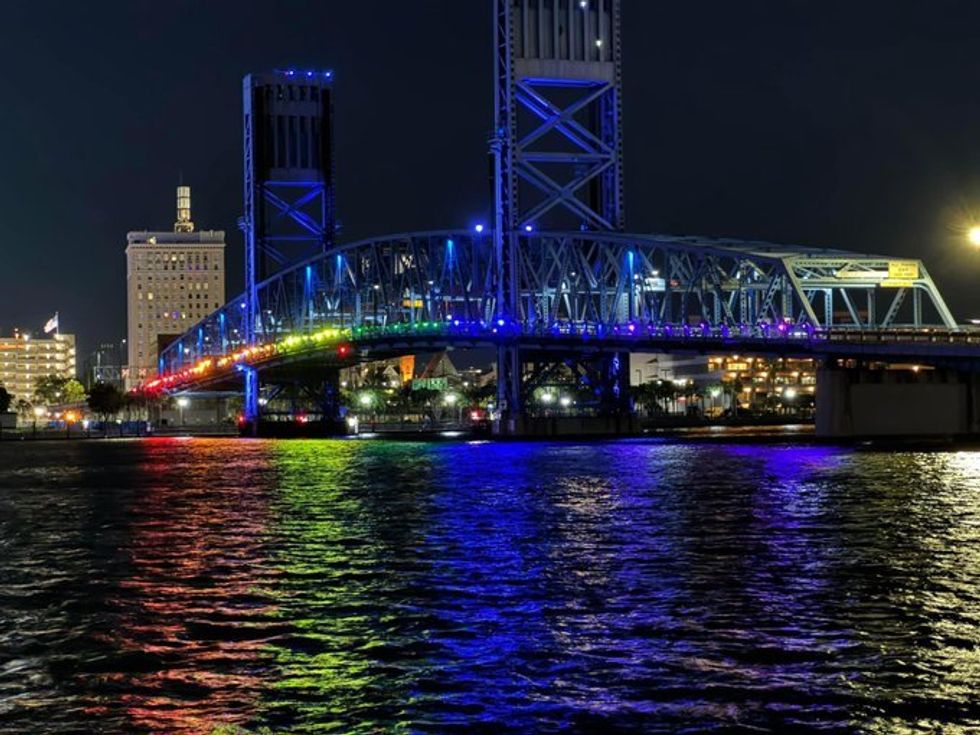 Photograph of Main Street Bridge lit up in Pride colors