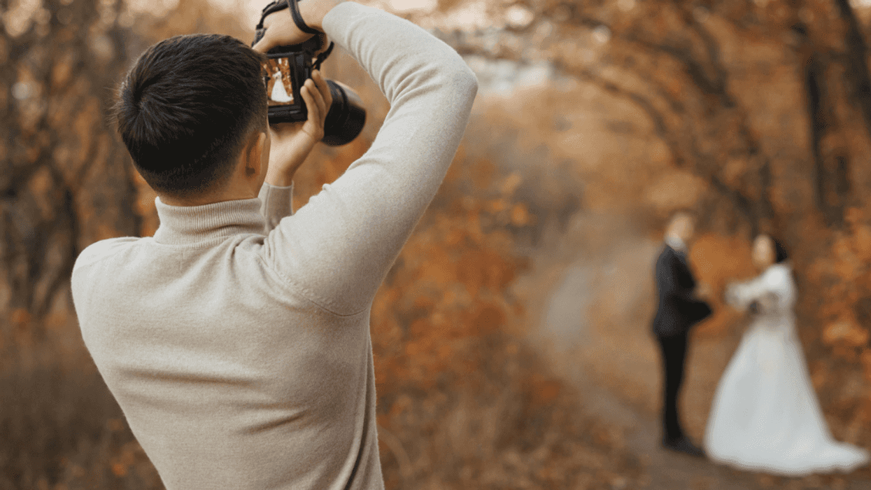 Photographer taking photos of newlyweds