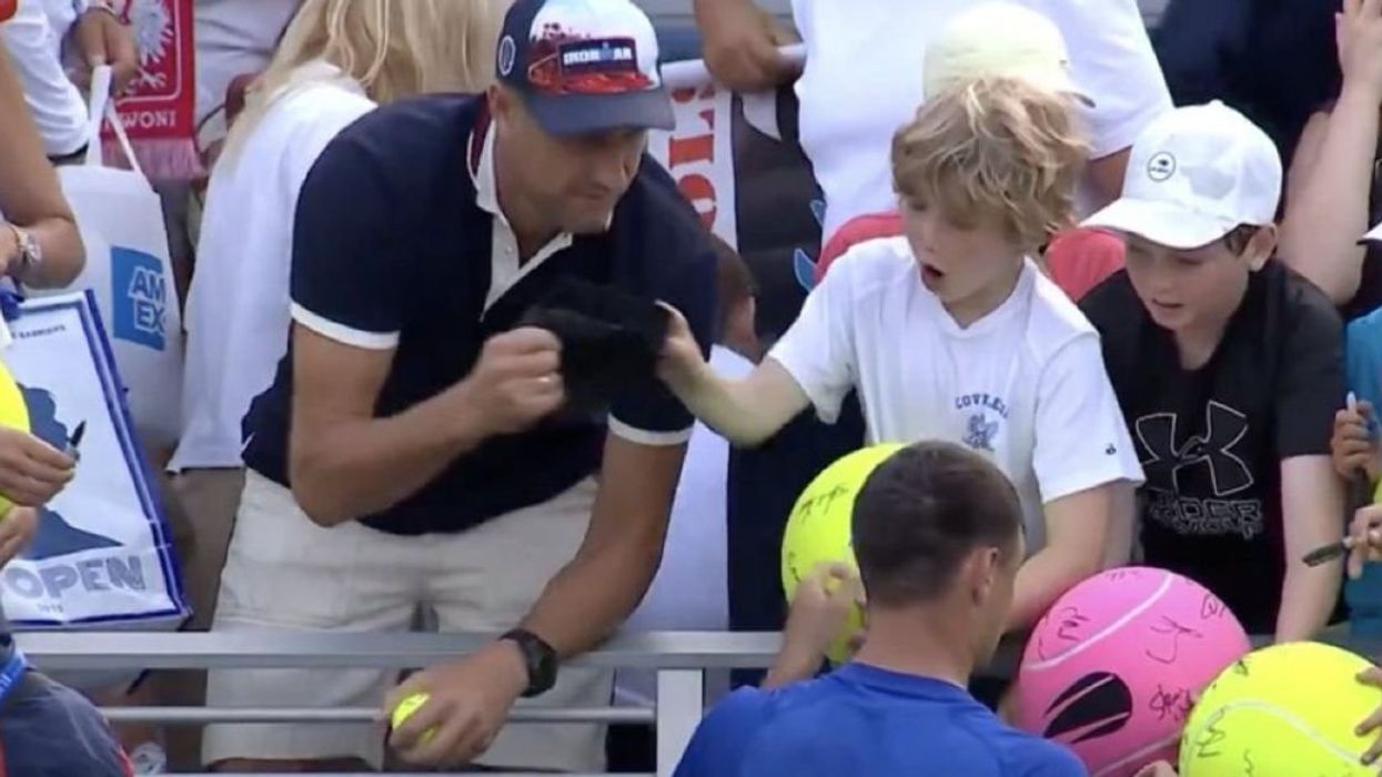 Piotr Szczerek snatching a hat from a young fan of Kamil Majchrzak at the U.S. Open