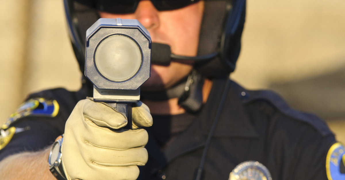 Police officer holding up a speed gun