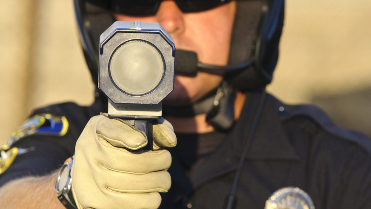 Police officer holding up a speed gun