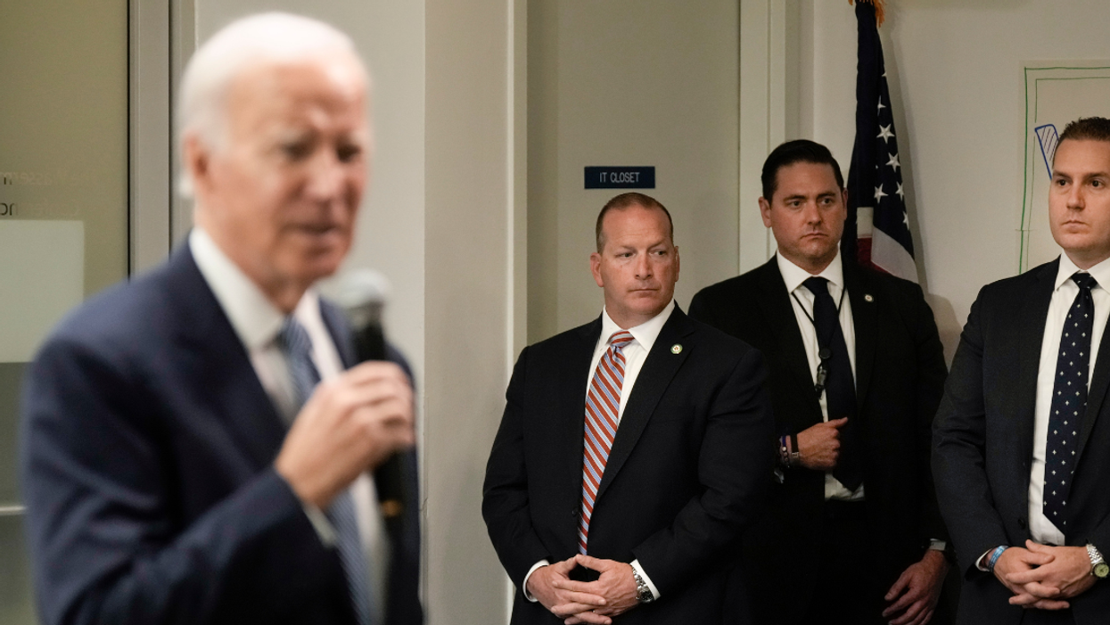 President Joe Biden in foreground with Secret Service agents in background