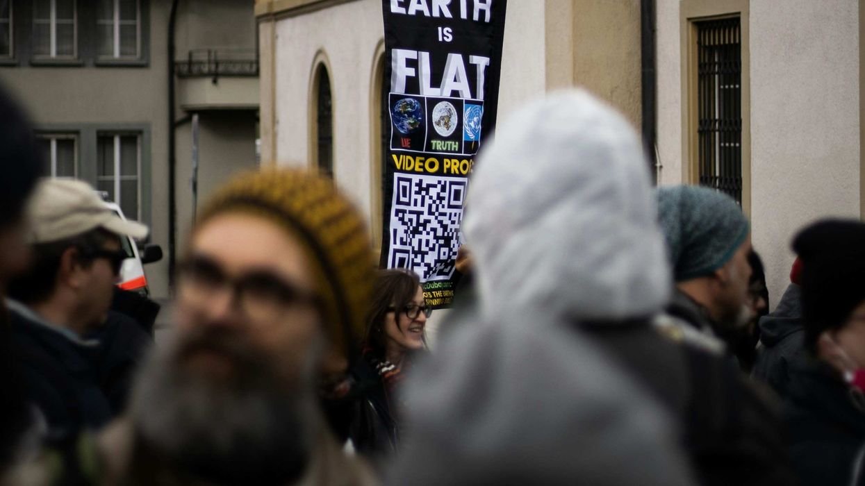 protest with flat Earth sign