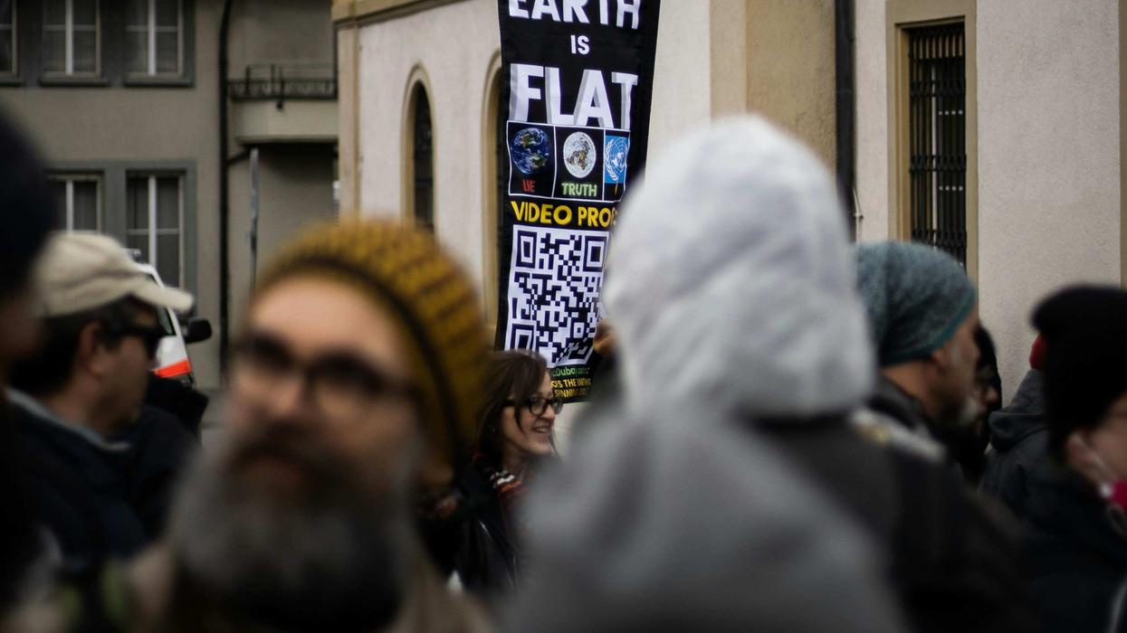 protest with flat Earth sign