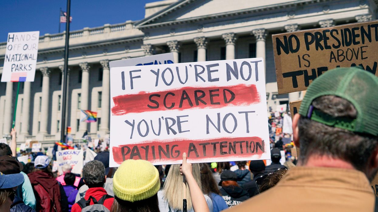 Protestors hold signs during a political demonstration