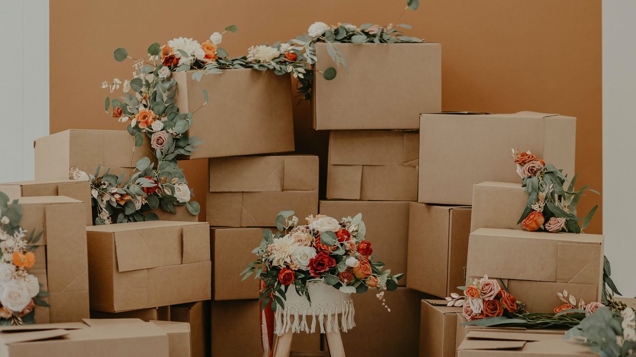 Red and white flowers decorating a pile of moving boxes