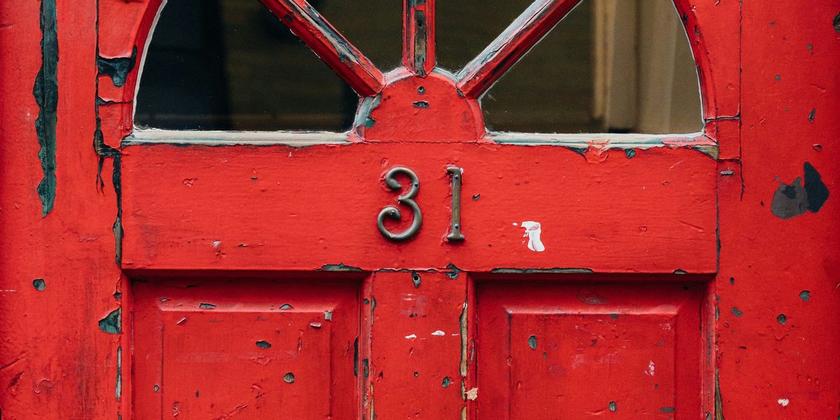 red wooden door with brass 31