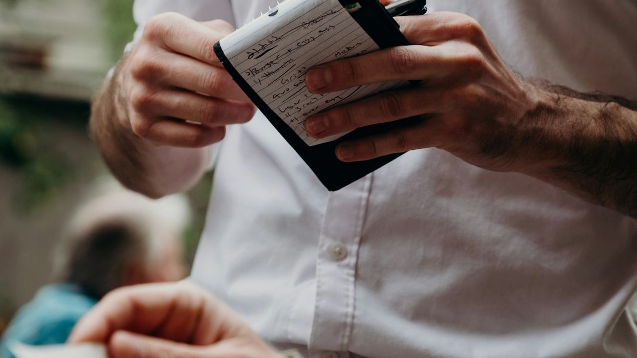 Restaurant server writing down meal order