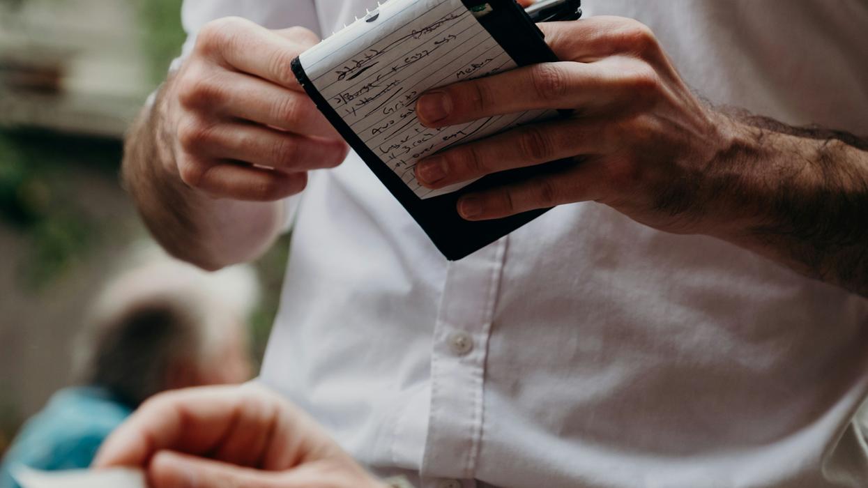 Restaurant server writing down meal order