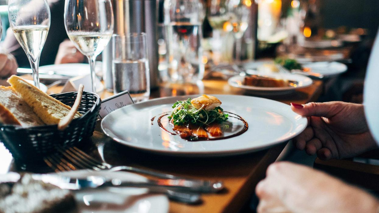 restaurant table set with dishes and food