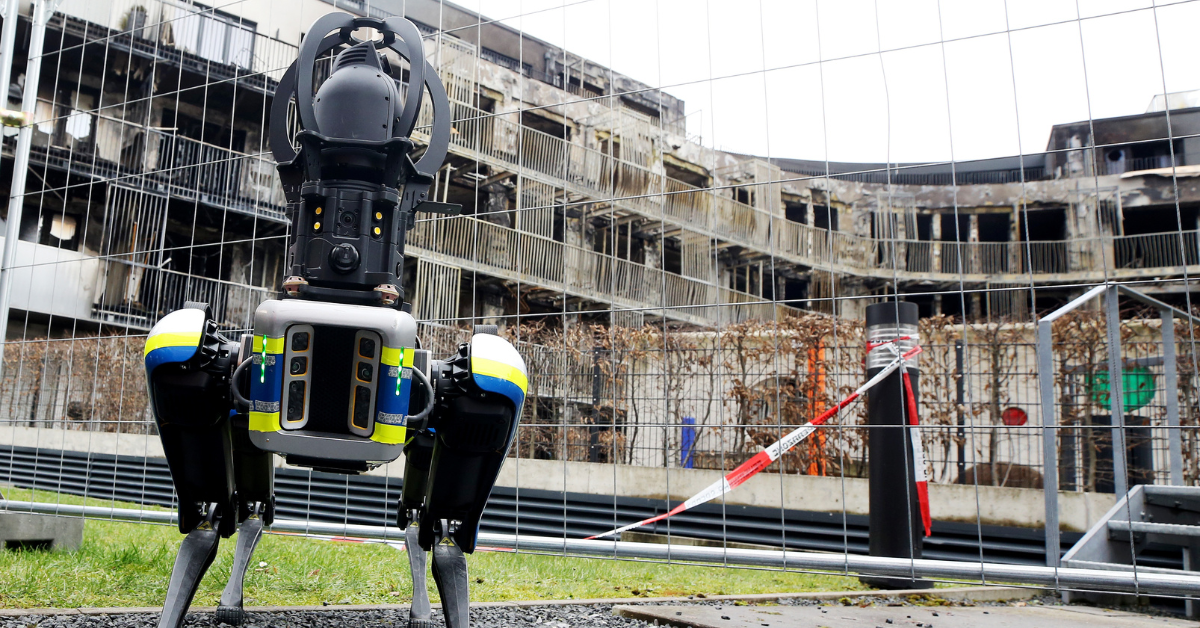 Robot with police stripes standing in an urban background