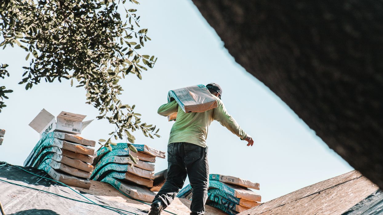roofer carrying shingles