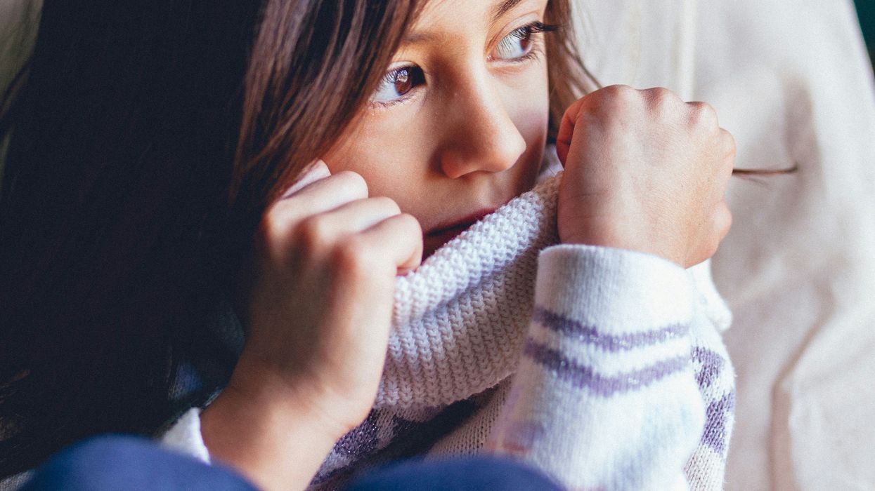 Sad girl looking out the window