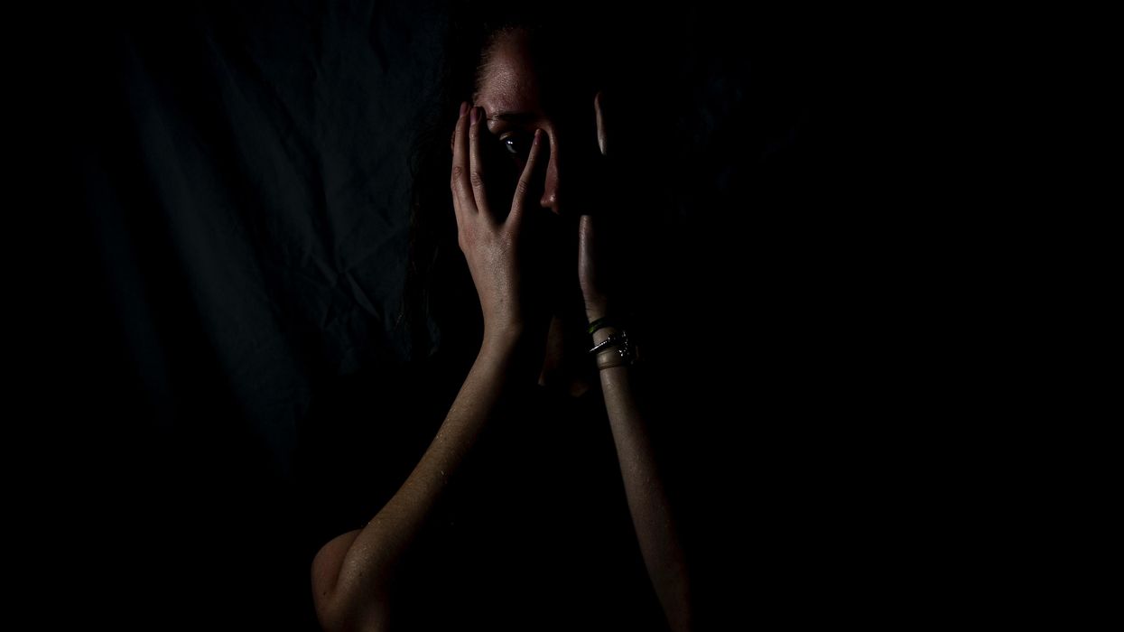 Scared woman covering her face