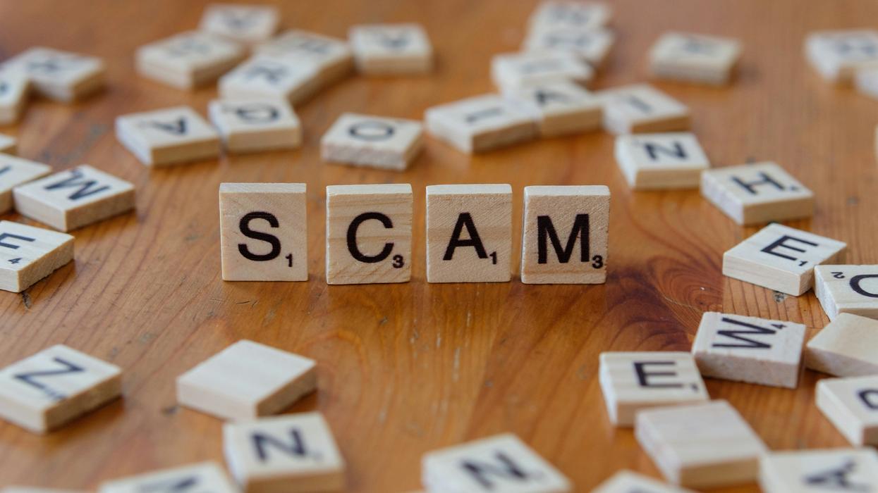 Scrabble tiles spelling the word scam