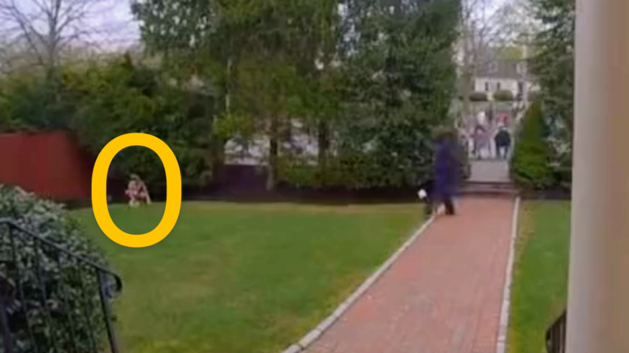 screenshot from homeowner's doorbell camera of Boston Marathon runner fertilizing the lawn