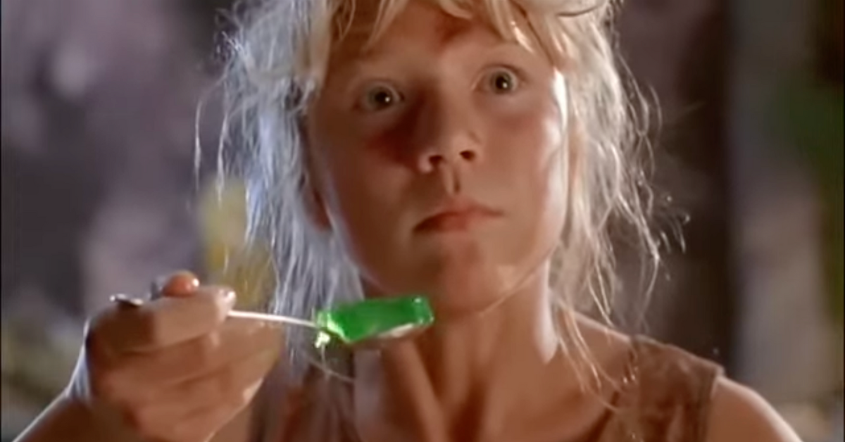 Screenshot from the movie Jurassic Park of character Lex Murphy holding a shaking spoonful of green Jello and looking frightened