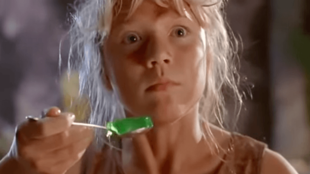 Screenshot from the movie Jurassic Park of character Lex Murphy holding a shaking spoonful of green Jello and looking frightened