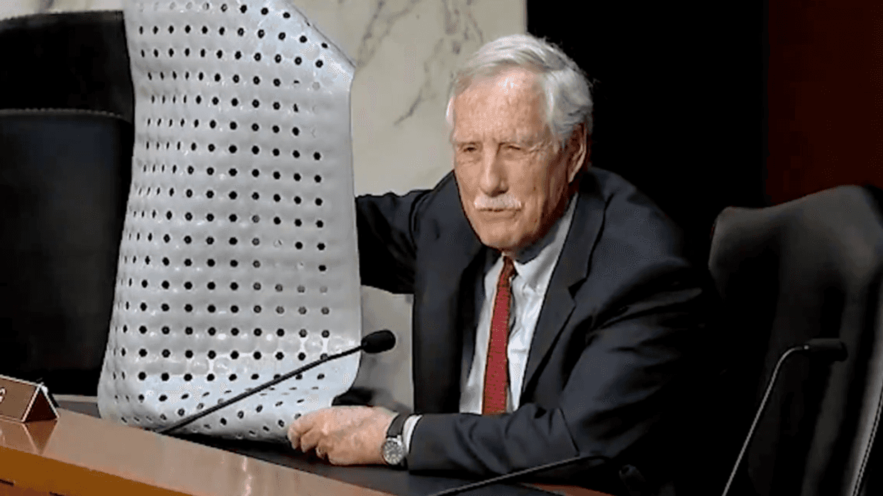 Screenshot of Angus King holding up bath mat